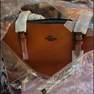 Still in original plastic. Beautiful coach fall bag! Burnt orange. Brand new!